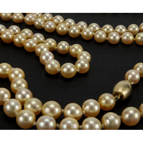 1048 - Three pearl necklaces with gold clasps, one set with sapphires, the largest 90cm in length, approxim... 