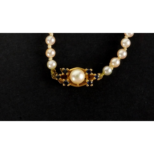 1048 - Three pearl necklaces with gold clasps, one set with sapphires, the largest 90cm in length, approxim... 