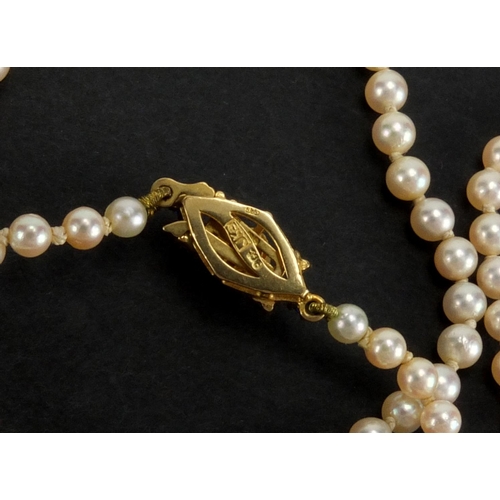 1048 - Three pearl necklaces with gold clasps, one set with sapphires, the largest 90cm in length, approxim... 