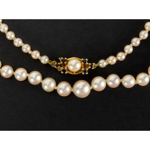 1048 - Three pearl necklaces with gold clasps, one set with sapphires, the largest 90cm in length, approxim... 