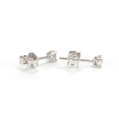 1025 - Pair of 18ct white gold diamond solitaire earrings, approximate weight 1.0g