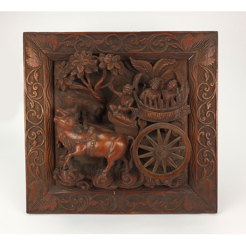 40 - Wood panel relief carved with figures in a cart, 52cm x 50cm