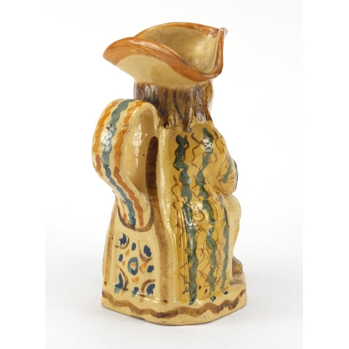 685 - 18th Century Ralph Wood type pottery toby jug in creamware colours, seated wearing a blue striped ye... 