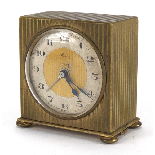 1135 - Art Deco brass travel alarm clock retailed by Reid  & Sons, with fitted case, 5.8cm high