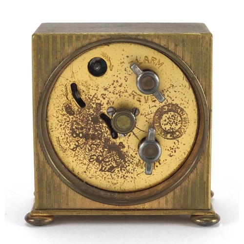 1135 - Art Deco brass travel alarm clock retailed by Reid  & Sons, with fitted case, 5.8cm high