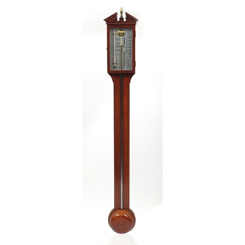 1142 - Mahogany wall stick barometer with silvered dial and broken arch pediment and urn finial, 97cm high