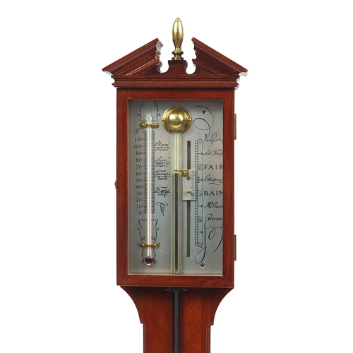 1142 - Mahogany wall stick barometer with silvered dial and broken arch pediment and urn finial, 97cm high