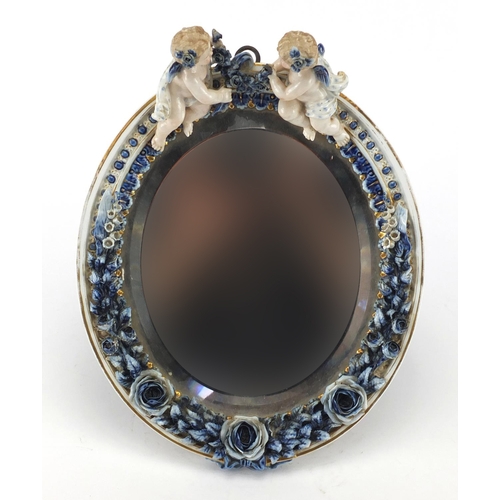 723 - 19th Century continental porcelain easel mirror with floral encrusted decoration, mounted with two c... 