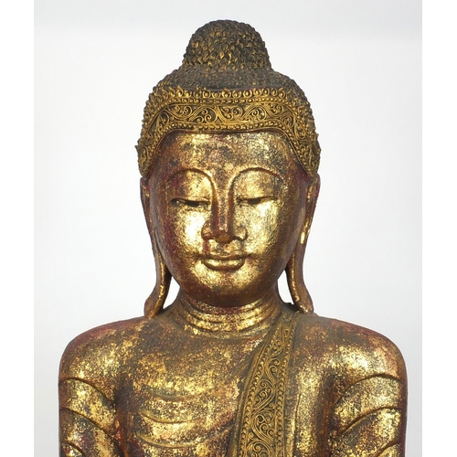 2032 - Large floor standing Thai carved wooden Buddha, hand painted and gilded, raised on a wooden stand, 2... 