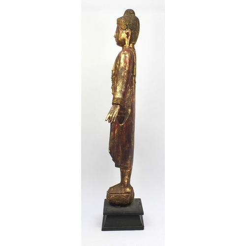 2032 - Large floor standing Thai carved wooden Buddha, hand painted and gilded, raised on a wooden stand, 2... 