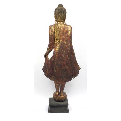 2032 - Large floor standing Thai carved wooden Buddha, hand painted and gilded, raised on a wooden stand, 2... 