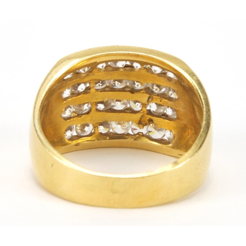 2538 - Stylish gold coloured metal ring set with four rows of clear stones, indistinct marks to the shank, ... 