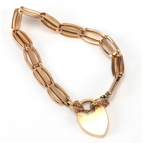 2522 - 9ct gold three row gate bracelet with love heart padlock, 16cm in length, approximate weight 12.2g