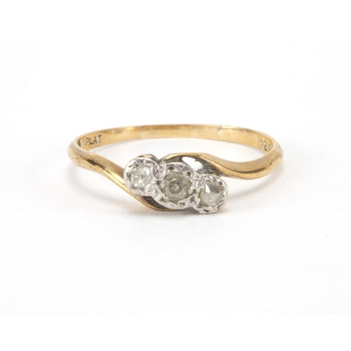 2564 - 9ct gold diamond three stone crossover ring, size R, approximate weight 1.6g