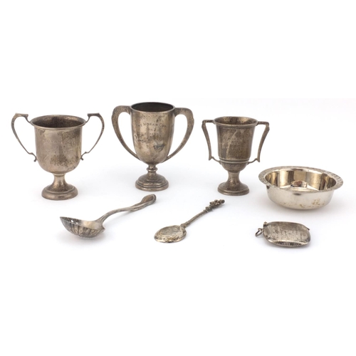 2407 - Silver items comprising three twin handle trophies, two spoons, rectangular vesta and a Guernsey sil... 