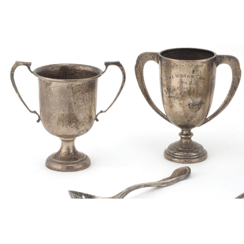 2407 - Silver items comprising three twin handle trophies, two spoons, rectangular vesta and a Guernsey sil... 