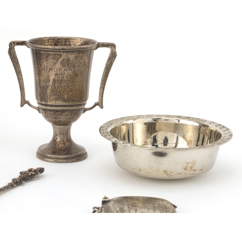 2407 - Silver items comprising three twin handle trophies, two spoons, rectangular vesta and a Guernsey sil... 