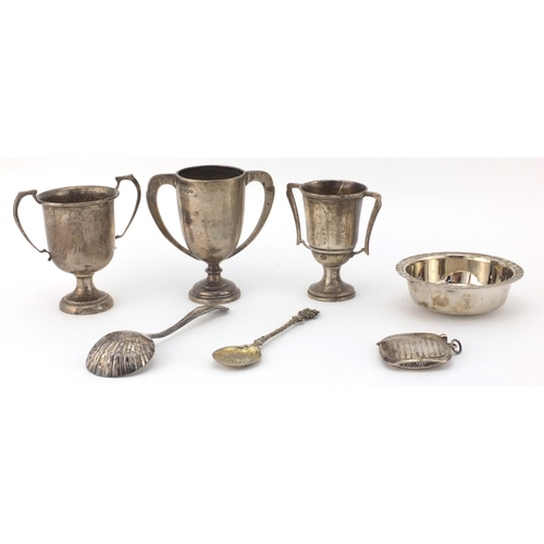 2407 - Silver items comprising three twin handle trophies, two spoons, rectangular vesta and a Guernsey sil... 