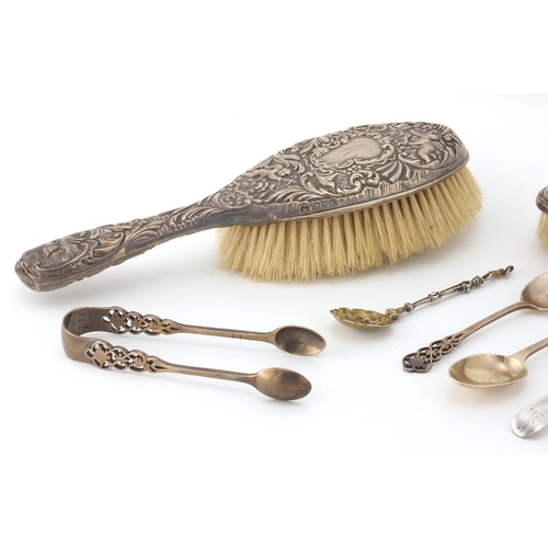 2437 - Silver items comprising two dressing table brushes, four tea spoons, a Georgian spoon and napkin rin... 