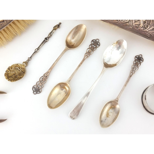 2437 - Silver items comprising two dressing table brushes, four tea spoons, a Georgian spoon and napkin rin... 