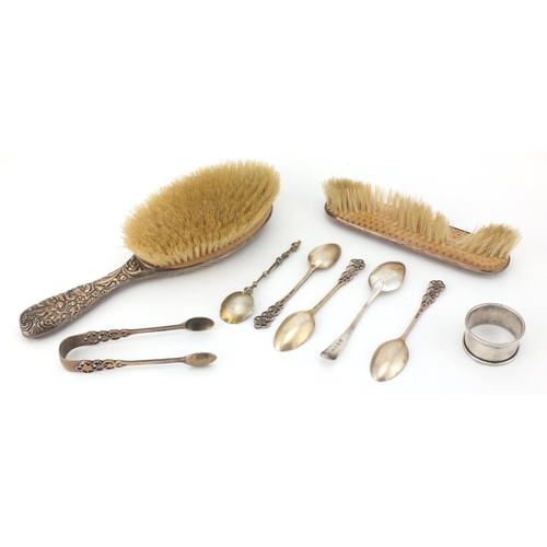 2437 - Silver items comprising two dressing table brushes, four tea spoons, a Georgian spoon and napkin rin... 