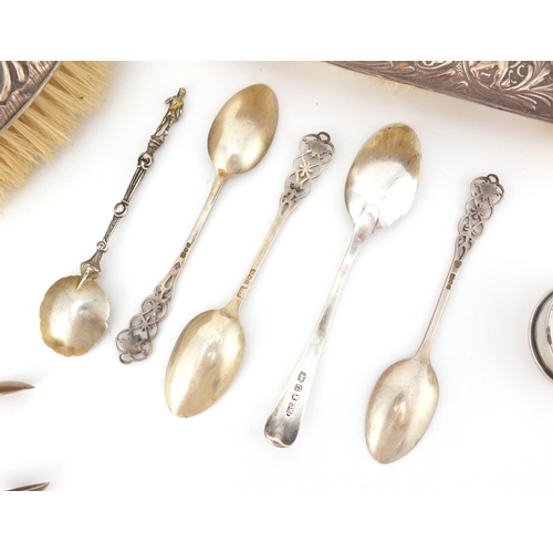 2437 - Silver items comprising two dressing table brushes, four tea spoons, a Georgian spoon and napkin rin... 