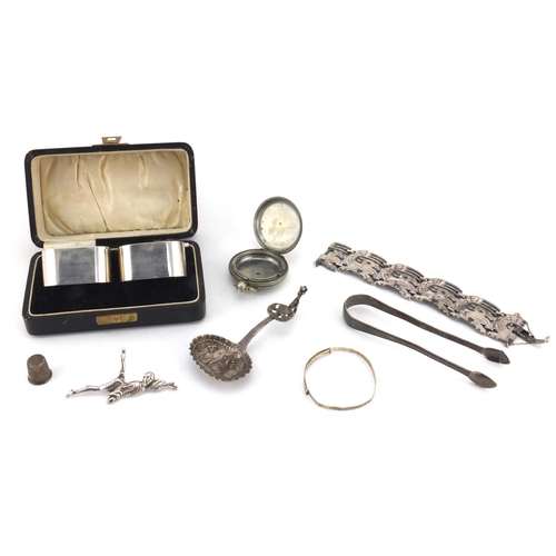 2427 - Silver and white metal items including a boxed pair of silver napkin rings, silver dancer brooch, Du... 