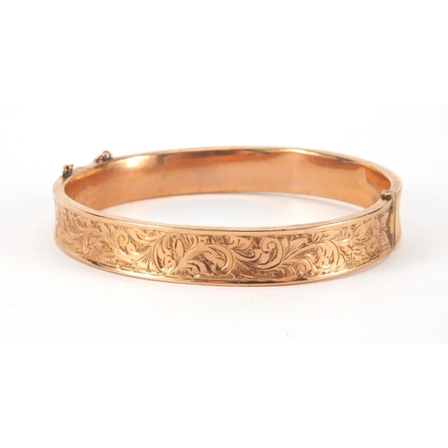 2517 - 9ct gold bangle with floral chased decoration, 6cm in diameter, approximate weight 13.8g