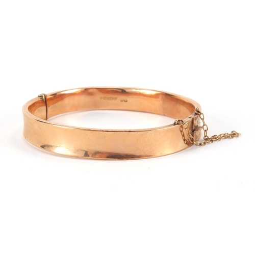 2517 - 9ct gold bangle with floral chased decoration, 6cm in diameter, approximate weight 13.8g