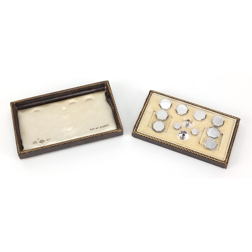 2563 - Set of sterling silver and Mother of Pearl cuff links and studs, housed in a tooled leather box