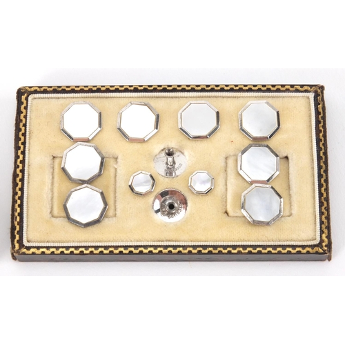 2563 - Set of sterling silver and Mother of Pearl cuff links and studs, housed in a tooled leather box