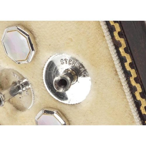 2563 - Set of sterling silver and Mother of Pearl cuff links and studs, housed in a tooled leather box