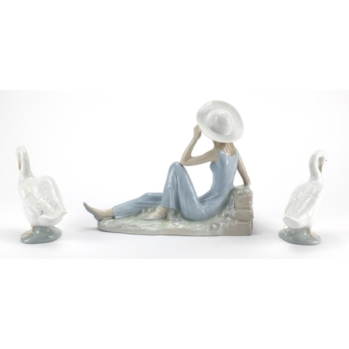 2362 - Nao figurine of a female seated beside flowers and two ducks, the largest 30cm in length