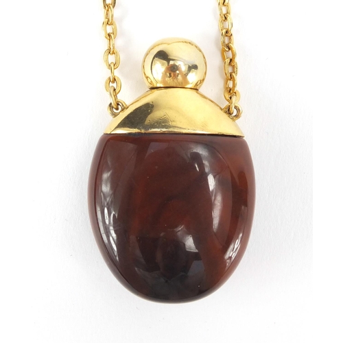 2394 - Givenchy Hautee Couture Bakelite perfume bottle on chain, the bottle 5cm in length