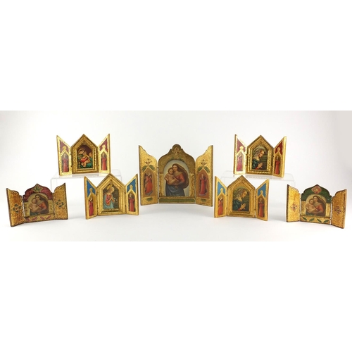 2399 - Seven religious gilt triptych icons, the largest 19cm high