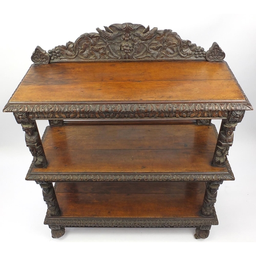 2039 - Victorian three tier oak buffet, carved with birds, vine leaves, grapes and face masks, 145cm H x 12... 