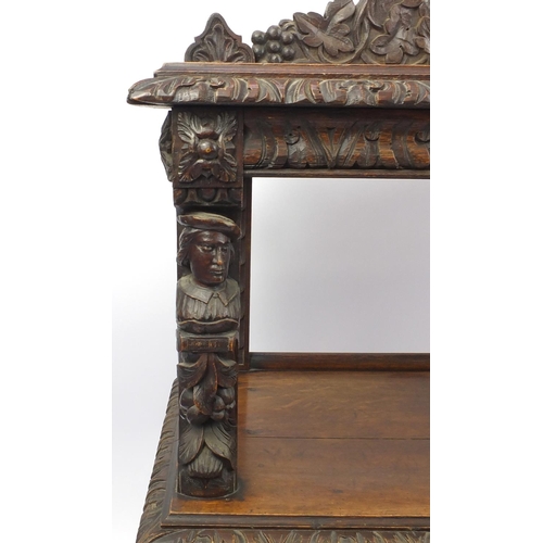 2039 - Victorian three tier oak buffet, carved with birds, vine leaves, grapes and face masks, 145cm H x 12... 