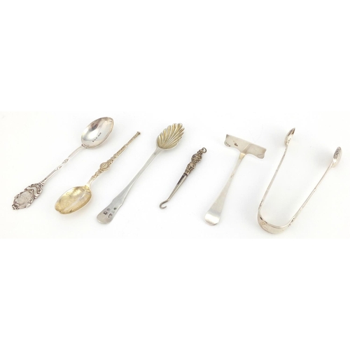 2433 - Silver items including a silver backed hand mirror embossed with cherubs, sugar tongs, spoons etc, v... 