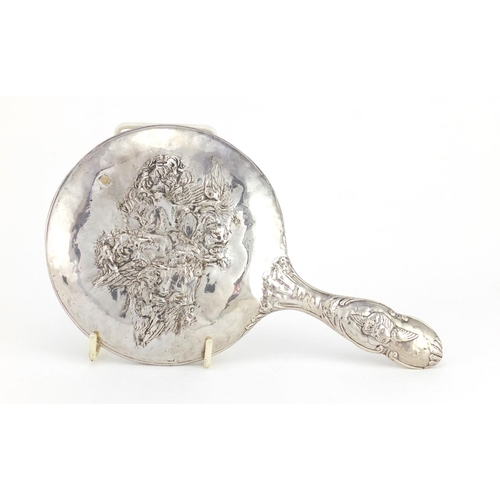 2433 - Silver items including a silver backed hand mirror embossed with cherubs, sugar tongs, spoons etc, v... 