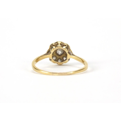 2545 - 9ct gold diamond flower head ring set with nine diamonds, size O, approximate weight 2.2g