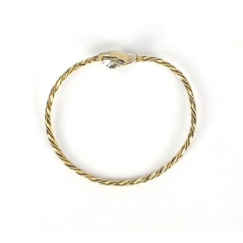 2577 - Gold coloured metal rope twist bangle set with sapphires, approximate weight 10.5g