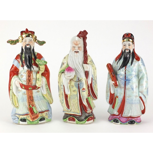 2372 - Three Chinese porcelain figures all hand painted in the famille rose palette, the largest 26cm high