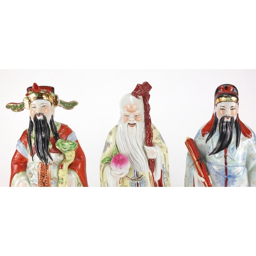 2372 - Three Chinese porcelain figures all hand painted in the famille rose palette, the largest 26cm high