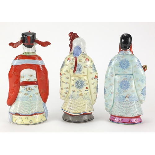 2372 - Three Chinese porcelain figures all hand painted in the famille rose palette, the largest 26cm high