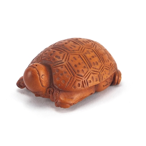 2389 - Chinese box wood netsuke of a man / tortoise, with character marks, 5cm in length