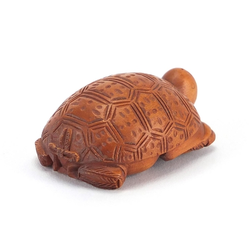 2389 - Chinese box wood netsuke of a man / tortoise, with character marks, 5cm in length