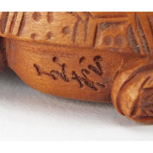 2389 - Chinese box wood netsuke of a man / tortoise, with character marks, 5cm in length