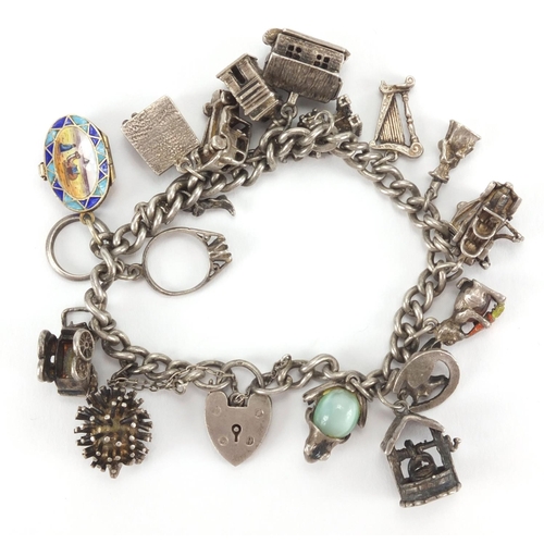 2586 - Silver charm bracelet with selection of mostly silver charms including enamelled Egyptian casket, gr... 