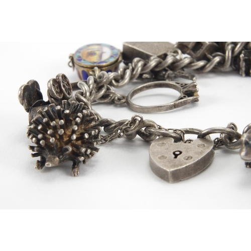 2586 - Silver charm bracelet with selection of mostly silver charms including enamelled Egyptian casket, gr... 