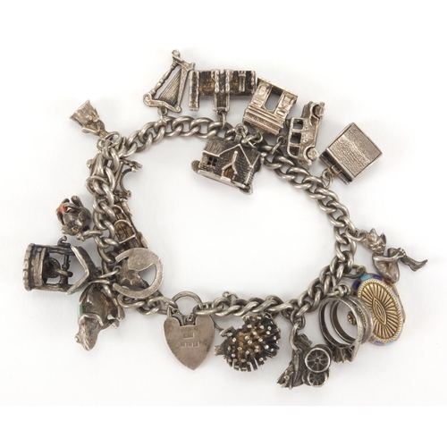 2586 - Silver charm bracelet with selection of mostly silver charms including enamelled Egyptian casket, gr... 